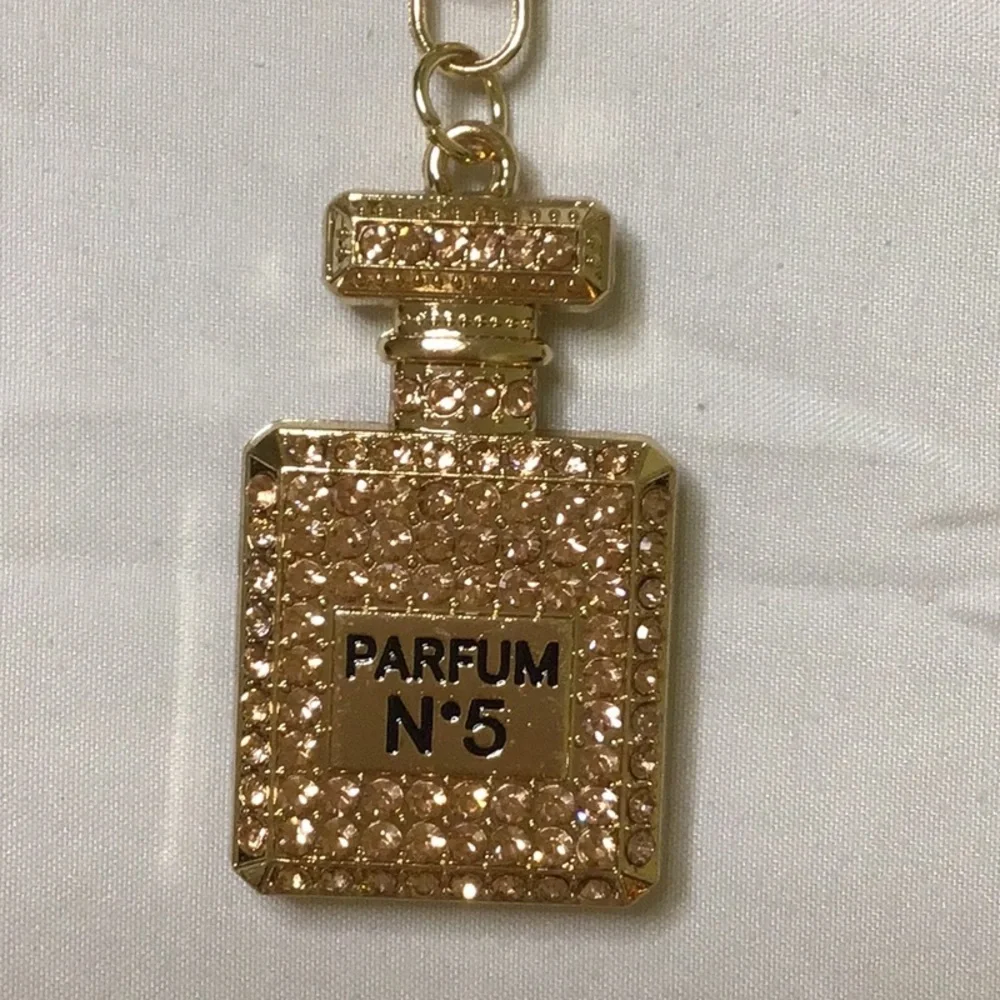 Gold finish Key Holder with‎ Perfume Bottle Design